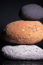 Zen concept black, orange and grey stone on black background Royalty Free Stock Photo