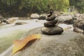 Zen garden with balance stone and flowing water on the river nature background. Life balance, peace, healing and harmony concept Royalty Free Stock Photo