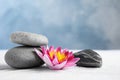 Zen garden. Beautiful lotus flower and stones on sand, space for text Royalty Free Stock Photo