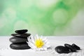 Zen garden. Beautiful lotus flower and stones on sand, space for text Royalty Free Stock Photo