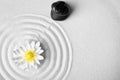 Zen garden. Beautiful lotus flower, stones and space for text on white sand Royalty Free Stock Photo