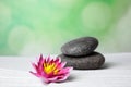 Zen garden. Beautiful lotus flower and stones on white Royalty Free Stock Photo