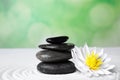 Zen garden. Beautiful lotus flower and stones on white Royalty Free Stock Photo