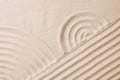 Zen garden pattern on sand as background, top view Royalty Free Stock Photo