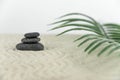 Zen garden. Pyramids of white and gray zen stones on the white sand with abstract wave drawings.