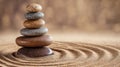 A zen garden with a stack of stones on a sand circle. The background is a warm, wooden texture Royalty Free Stock Photo