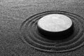 Zen garden stone on black sand with pattern Royalty Free Stock Photo