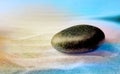 Zen garden stone on sand with pattern, space for text. Meditation and harmony Royalty Free Stock Photo