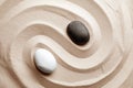 Zen garden stones on sand with pattern, top view