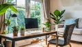 Zen home office with computer in a beautiful, spacious living room interior with plants and an outside view through big windows Royalty Free Stock Photo