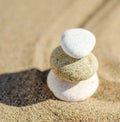 zen meditation stone in sand, concept for purity harmony and spirituality, spa wellness and yoga background Royalty Free Stock Photo