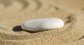 zen meditation stone in sand, concept for purity harmony and spirituality, spa wellness and yoga background Royalty Free Stock Photo