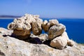 Zen outdoors stacked rocks balanced stones stack pyramid bridge with sea coast background water beach ocean horizon Royalty Free Stock Photo