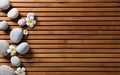 Zen pebbles and spa flowers set on hammam wooden board Royalty Free Stock Photo