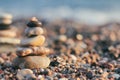 Zen pyramid of spa stones on the blurred sea background. Sand on a beach. Sea shores. Place for text. Sea view. Royalty Free Stock Photo