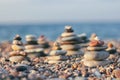 Zen pyramid of spa stones on the blurred sea background. Sand on a beach. Sea shores. Place for text. Sea view. Royalty Free Stock Photo