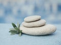 Zen pyramid of spa stones on the blurred sea background. Sand on a beach. Sea shores. Water waves texture. Left side of photo. Pla Royalty Free Stock Photo