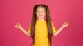 Zen. Relaxed Little Girl Meditating With Closed Eyes Over Pink Background Royalty Free Stock Photo