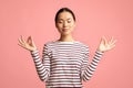 Zen. Relaxed Peaceful Asian Woman Meditating With Closed Eyes Over Pink Background