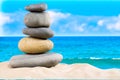 Zen rock, concept of harmony and balance. Zen stones pyramid on the beach with amazing turquoise blue water sea and sky Royalty Free Stock Photo