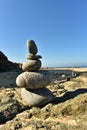 Zen rock stack on Pacific Ocean coast with waves on shore Royalty Free Stock Photo