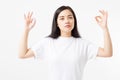 Zen sign. Calm asian girl in blank white t shirt isolated on template background. Copy space