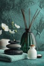 Zen Spa Atmosphere with Aromatic Candle, Stones, and Orchids on Textured Background Royalty Free Stock Photo