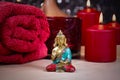 Zen spa still life with a buddha statue, red towel and candle stock photo images Royalty Free Stock Photo