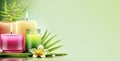 Zen, spa, wellness banner. Flowers, candles, green leaves on a pale yellowish-green background. Copy space