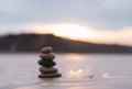 Zen stack stone on sea sand beach with blurry sunset background,Image Landscape pebble rock tower pyramid concept for stability, Royalty Free Stock Photo