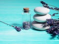 Zen stack stones on a blue wooden background, lavender seeds in a bottle and lavender branches nearby Royalty Free Stock Photo