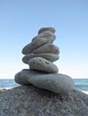 Zen stone cairn near the sea. Harmony and balance concept. Simple poise pebbles, rock tower. Beach stones stack Royalty Free Stock Photo