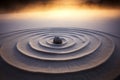 Zen stone in circular sand patterns at sunrise Royalty Free Stock Photo