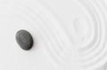 Zen Stone in Japanese garden with grey rock sea stone on white sand texture background, Yin and Yang symbol of dualism in ancient