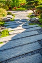 Zen stone path in a Japanese Garden with gravel and bark mulch and native plants Royalty Free Stock Photo