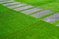 Zen stone path way in Japanese steps Garden with green synthetic grass Royalty Free Stock Photo