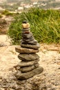 Zen stones. Balance Stones On Stone. Stones balance, pile of pebbles on sand and a bottom of green vegetation