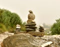 Zen stones. Balance Stones On Stone. Stones balance, pile of pebbles on sand and a bottom of green vegetation Royalty Free Stock Photo