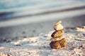 Zen Stones on beach for perfect meditation. Calm zen meditate background with rock pyramid on sand beach symbolizing stability, ha