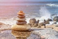 Zen stones on beach, Walking person on background