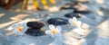 Zen stones and frangipani blossom on the beach Royalty Free Stock Photo