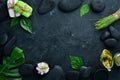 Zen stones and leaves with water drops. Spa background with spa accessories on a dark background. Top view. Free space Royalty Free Stock Photo
