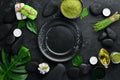 Zen stones and leaves with water drops. Spa background with spa accessories on a dark background. Top view. Free space Royalty Free Stock Photo