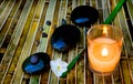 Zen stones and lit candle Royalty Free Stock Photo