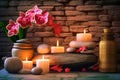 Zen stones, orchid flowers and aromatic candles spa arrangement on wooden table