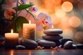 Zen stones, orchid flowers and aromatic candles spa arrangement on wooden table Royalty Free Stock Photo