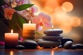 Zen stones, orchid flowers and aromatic candles spa arrangement on wooden table Royalty Free Stock Photo