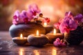 Zen stones, orchid flowers and aromatic candles spa arrangement on wooden table Royalty Free Stock Photo