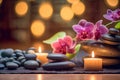 Zen stones, orchid flowers and aromatic candles spa arrangement on wooden table