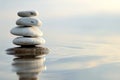 Zen stones with reflection on water at sunset Royalty Free Stock Photo